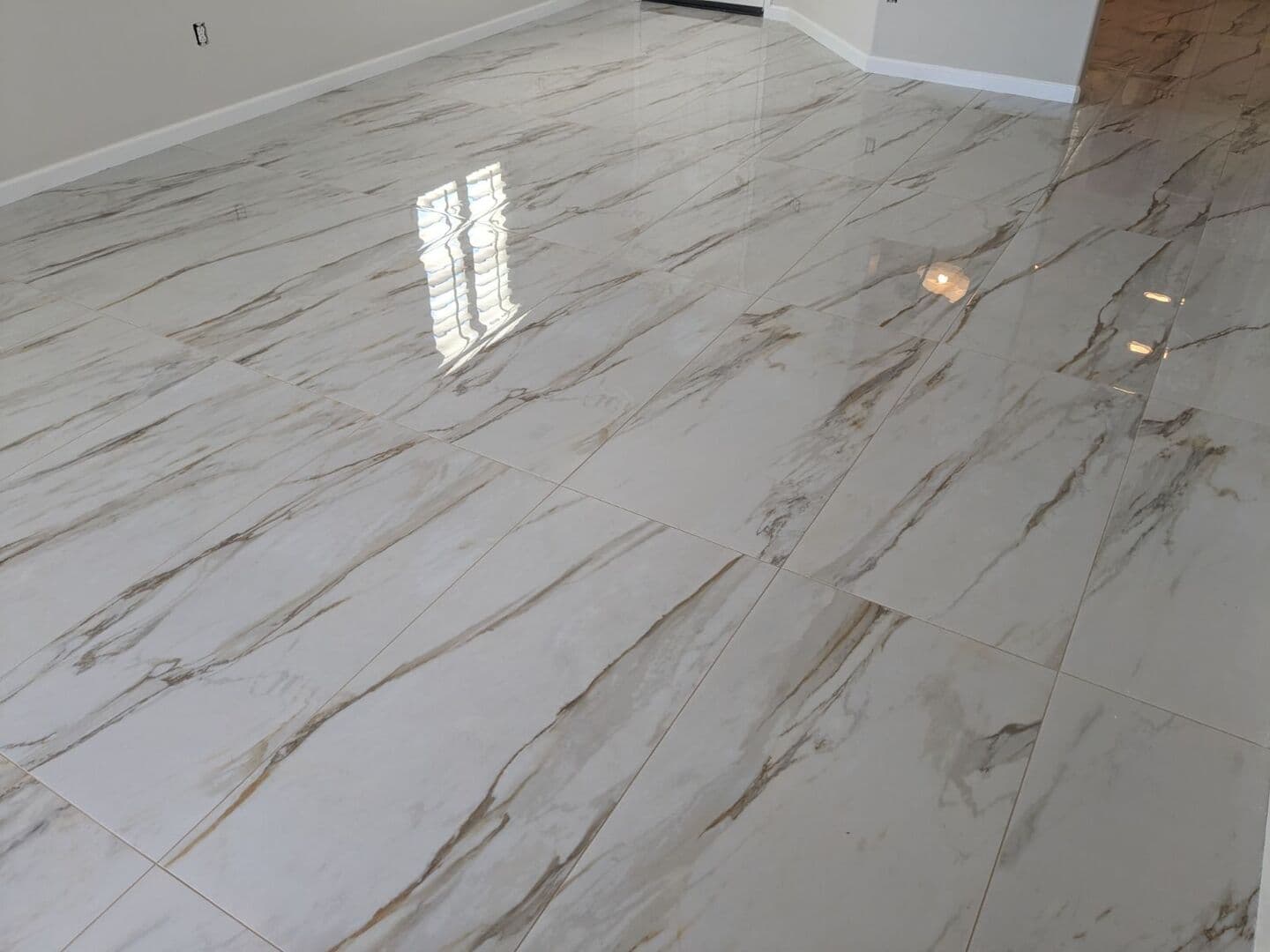 Polished calacatta marble-look large-format porcelain floor across an open room