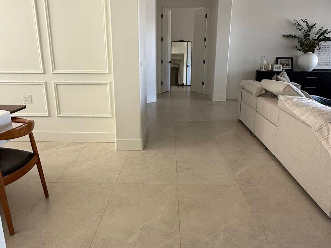 Large-format stone-look porcelain floor down a hallway with wainscoting