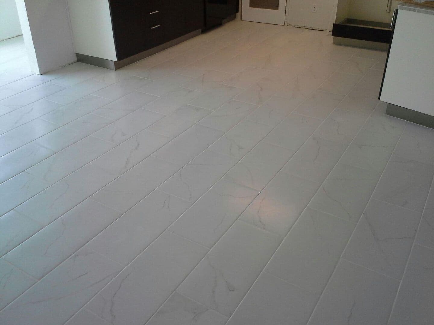 White marble-look porcelain floor through a kitchen