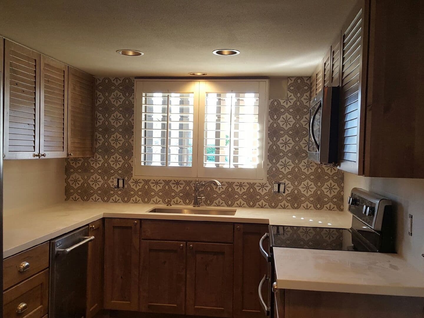Kitchen with a patterned tile backsplash wall and white subway tile