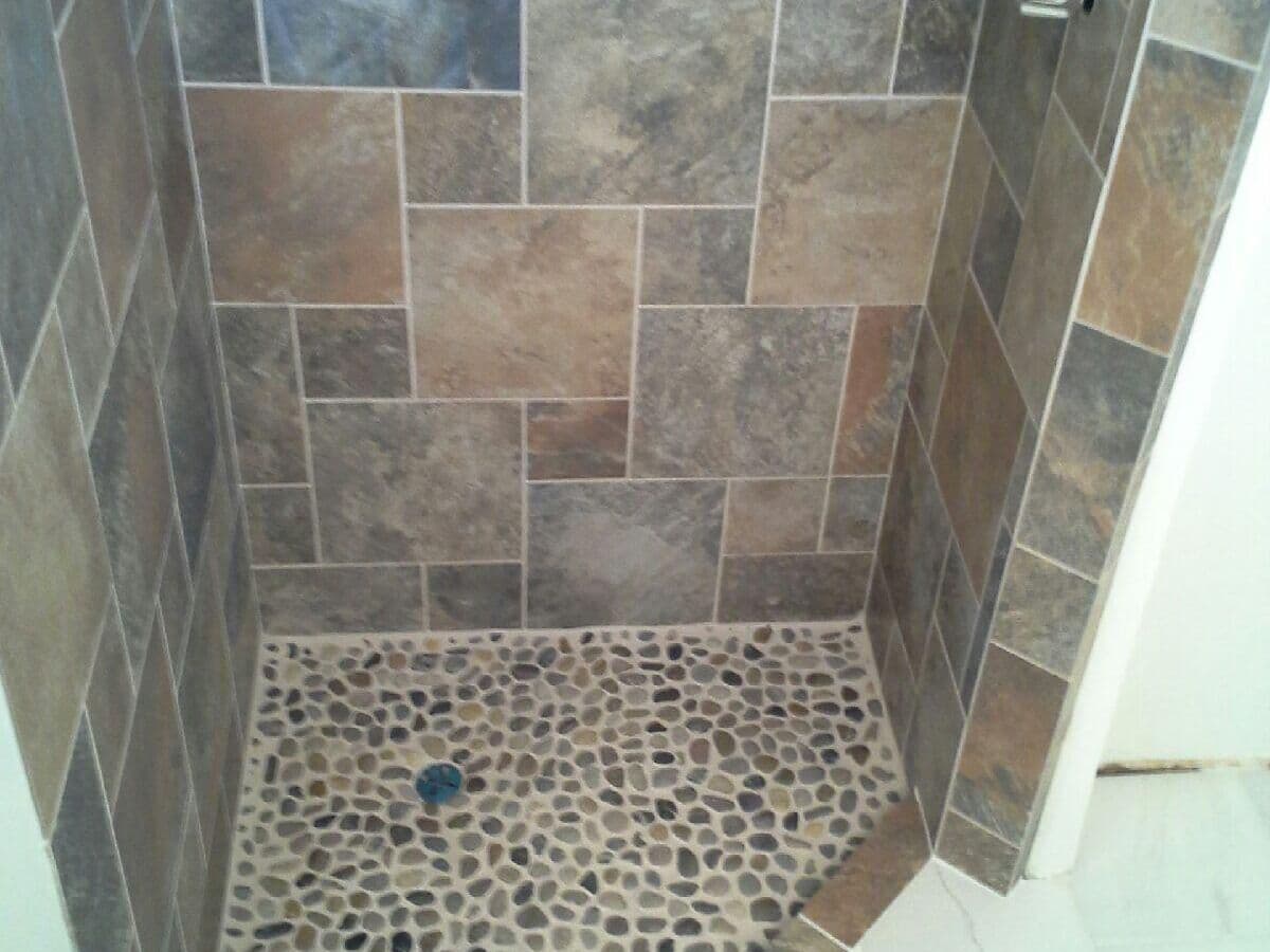 Shower in slate-look porcelain with a pebble mosaic floor